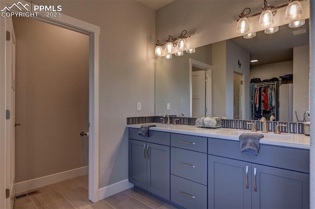 bathroom with tile flooring, double sink, and oversized vanity