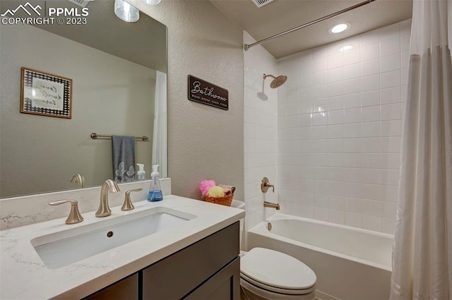 full bathroom featuring shower / bath combination with curtain, oversized vanity, and toilet