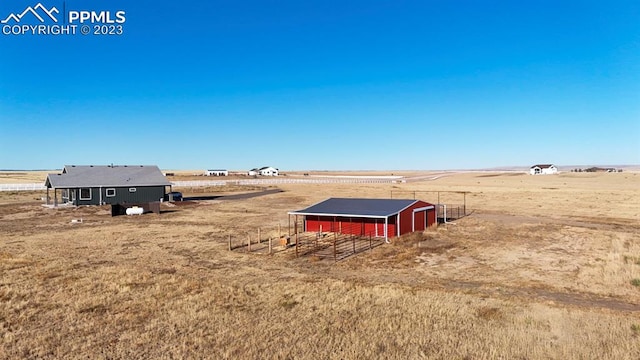 view of yard with a rural view and an outdoor structure