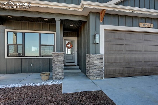 entrance to property with covered porch and a garage