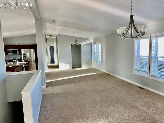 9785 N Calhan Hwy, Calhan, CO 80808 - empty room with visible vents, carpet, baseboards, a chandelier, and vaulted ceiling