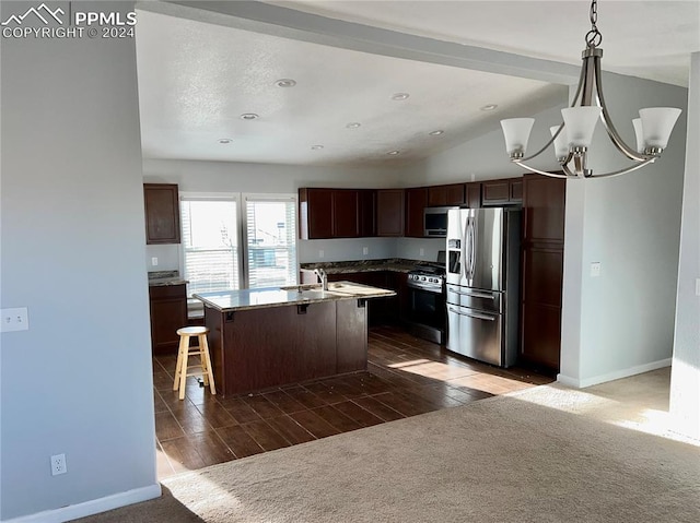 9785 N Calhan Hwy, Calhan, CO 80808 - kitchen featuring baseboards, an inviting chandelier, an island with sink, vaulted ceiling, and appliances with stainless steel finishes