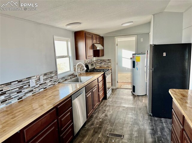 9785 N Calhan Hwy, Calhan, CO 80808 - kitchen featuring electric water heater, vaulted ceiling, stainless steel appliances, wood counters, and a sink