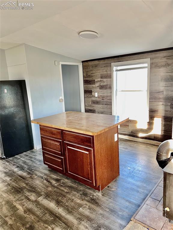 9785 N Calhan Hwy, Calhan, CO 80808 - kitchen featuring wooden counters, wooden walls, and dark wood finished floors