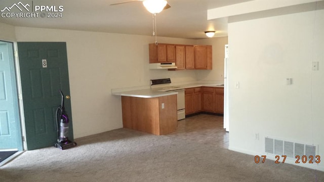 kitchen with light carpet, white stove, and ceiling fan