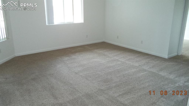 empty room featuring light carpet