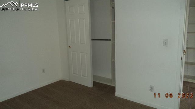 unfurnished bedroom featuring dark colored carpet