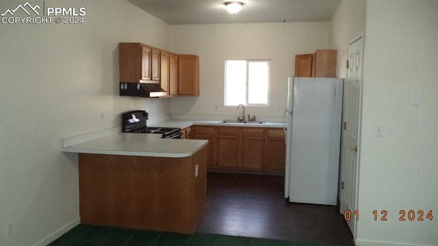 kitchen with black stove, kitchen peninsula, range hood, sink, and white refrigerator