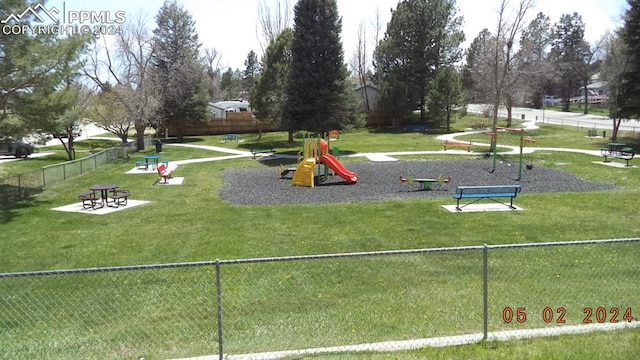 view of property's community featuring a yard and a playground