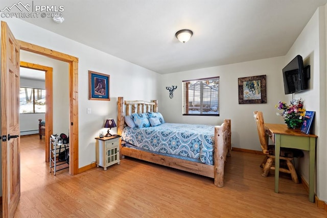 bedroom featuring wood-type flooring and baseboard heating