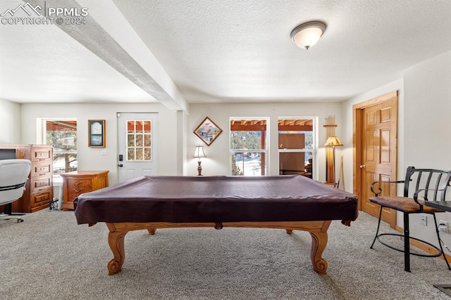 rec room featuring a textured ceiling, pool table, and carpet flooring