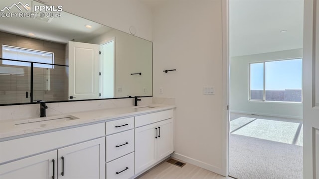 bathroom with plenty of natural light and double vanity