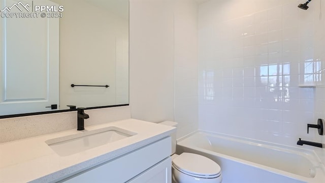 full bathroom with vanity, tiled shower / bath combo, and toilet