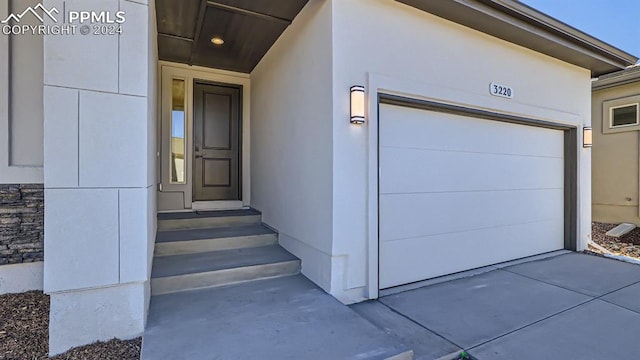 doorway to property featuring a garage