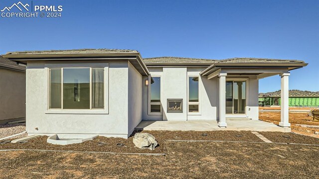 exterior space featuring stucco siding and a patio area
