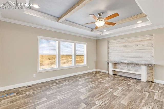 unfurnished living room with ornamental molding, a raised ceiling, light hardwood / wood-style floors, and ceiling fan