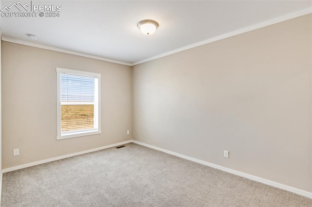 unfurnished room with light carpet and crown molding