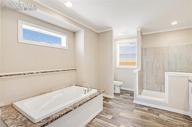 bathroom featuring toilet, hardwood / wood-style floors, and a bath