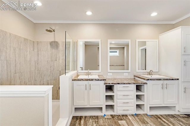 bathroom with ornamental molding, dual sinks, hardwood / wood-style floors, and oversized vanity