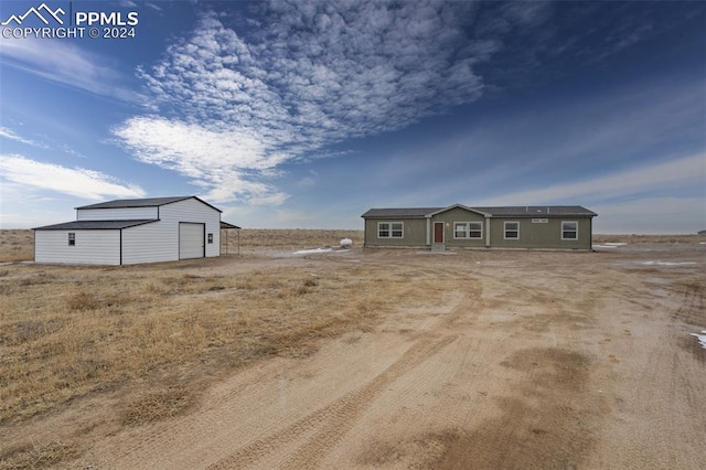 view of front of property featuring an outdoor structure and a garage