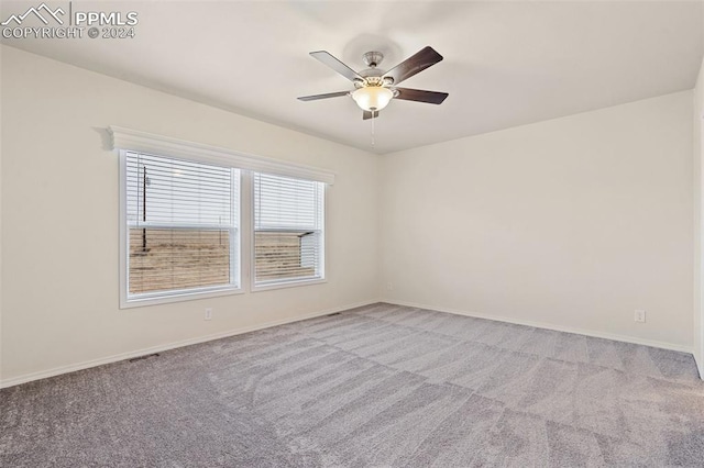 unfurnished room with ceiling fan and light carpet