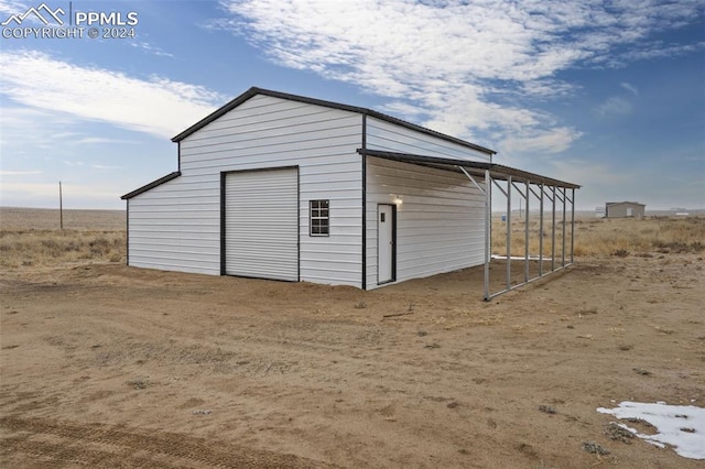 view of shed / structure with a rural view