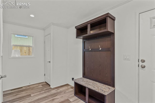 mudroom featuring light wood-type flooring and crown molding