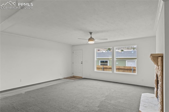 unfurnished living room with ceiling fan, crown molding, and light colored carpet