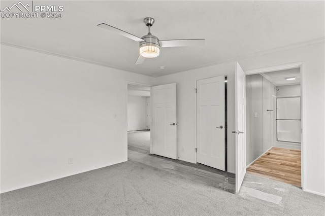 unfurnished room with crown molding, ceiling fan, and light colored carpet