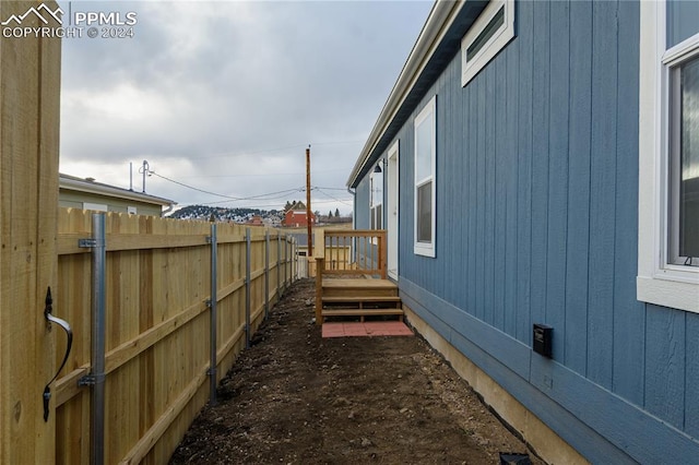 view of property exterior with a wooden deck