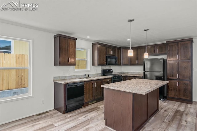 kitchen with a center island, decorative light fixtures, dark brown cabinetry, light hardwood / wood-style flooring, and black appliances