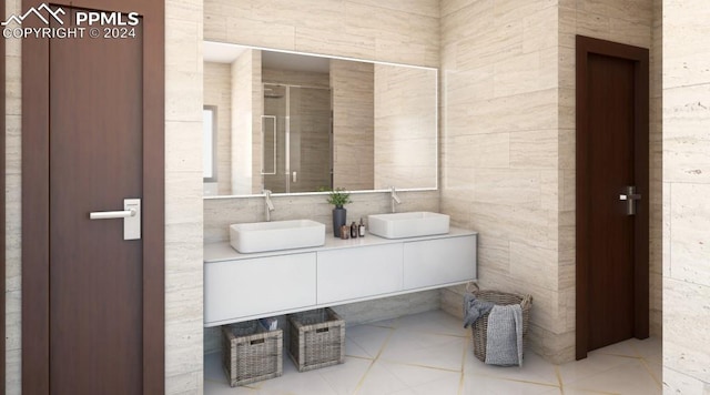 bathroom featuring dual sinks, tile walls, tile floors, and vanity with extensive cabinet space