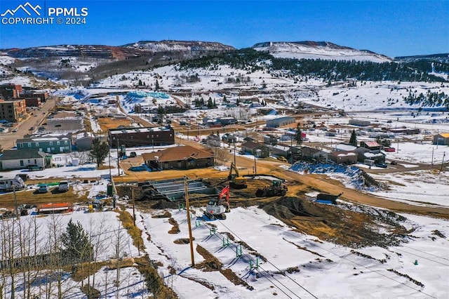 snowy aerial view with a mountain view