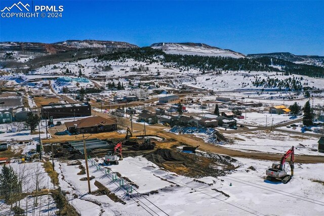 snowy aerial view featuring a mountain view