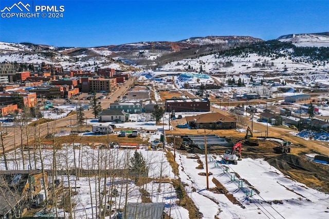 snowy aerial view featuring a mountain view