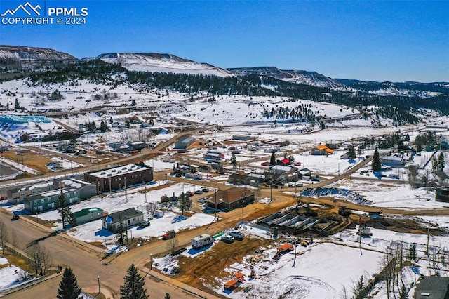 snowy aerial view with a mountain view