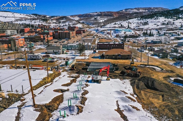 snowy aerial view featuring a mountain view