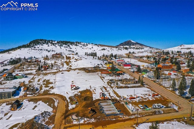 snowy aerial view with a mountain view