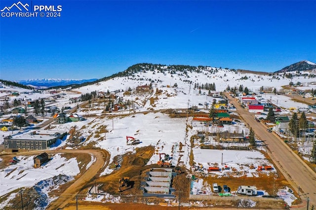 snowy aerial view with a mountain view