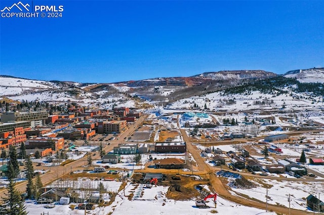 snowy aerial view with a mountain view