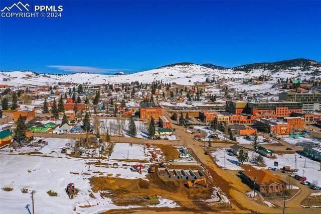 snowy aerial view with a mountain view