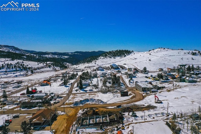 snowy aerial view with a mountain view