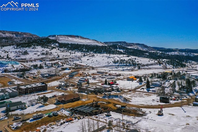 snowy aerial view with a mountain view