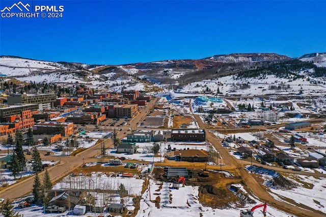 snowy aerial view featuring a mountain view