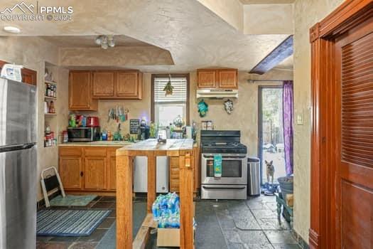 kitchen featuring tile floors and stainless steel appliances