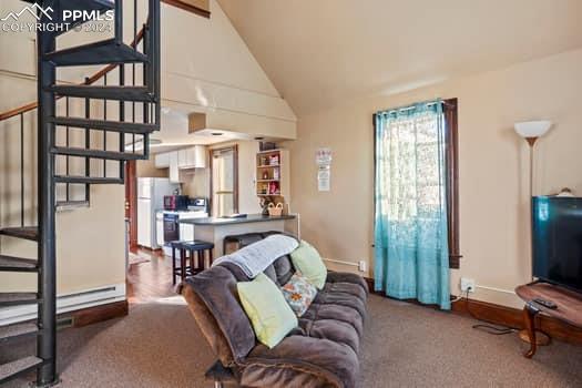 living room featuring high vaulted ceiling and dark carpet