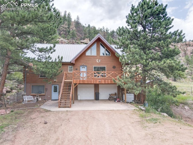 log-style house featuring a garage