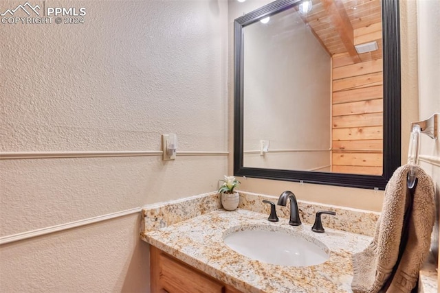 bathroom featuring oversized vanity and wooden ceiling