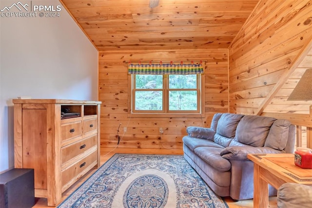 sitting room featuring wooden walls, wooden ceiling, and vaulted ceiling