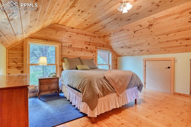 bedroom featuring lofted ceiling, light hardwood / wood-style floors, and wood ceiling